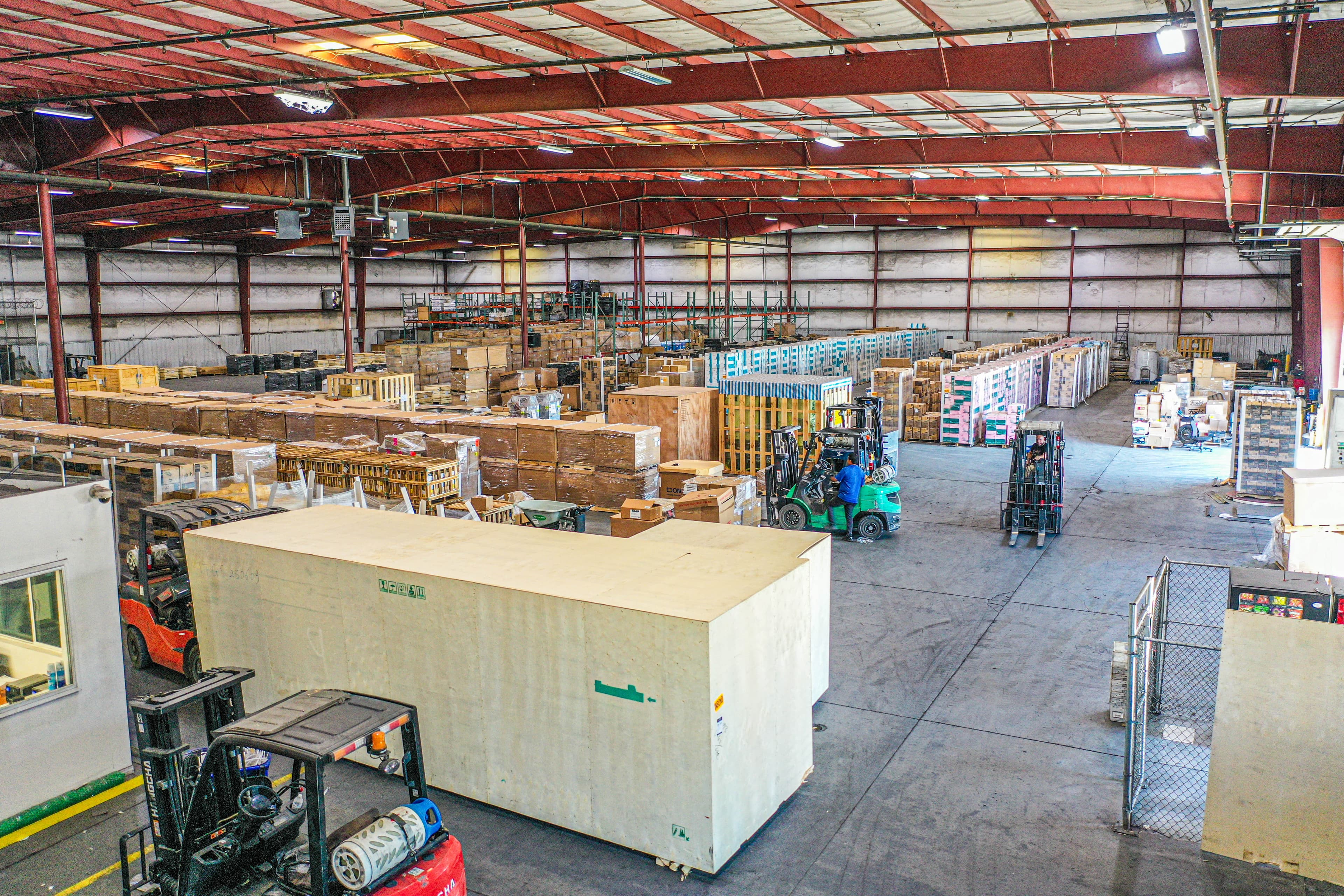 Aerial drone view of warehouse complex showing building structures and yard